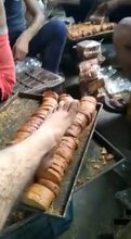 Factory Workers Lick And Rest Their Sweaty Feet On Bread Rusks Before Packing Them Up To Be Sold
