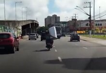  Biker Couple Move Giant Washing Machine On Busy Road